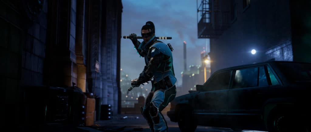 Image of Dick Grayson from the Gotham Knights Nightwing Character Trailer standing in a fighting pose near a car in a back alley